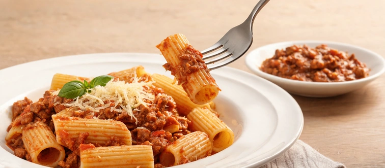 This ribbed, tubular shape is designed to scoop up chunky vegetable and meat sauces perfectly