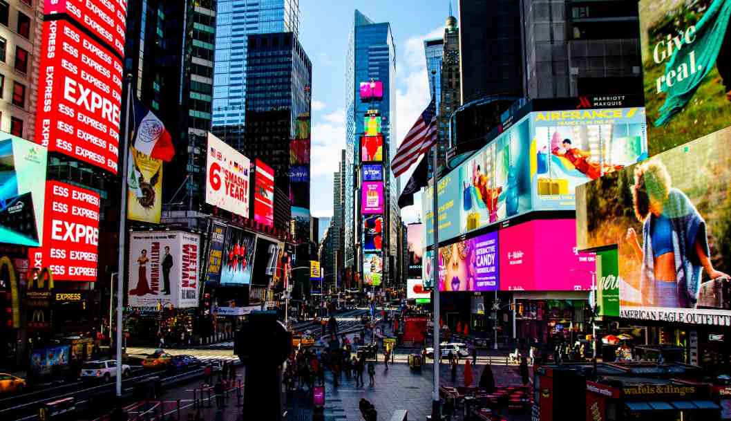 Let's serve up a classic: which iconic spot glows with massive, eye-catching advertisements and a truly electric atmosphere?