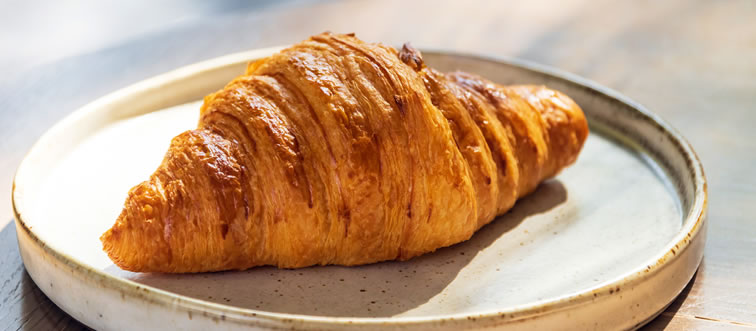 Picture a golden-brown, crescent-shaped masterpiece fresh out of a Parisian oven. What are we slicing into?