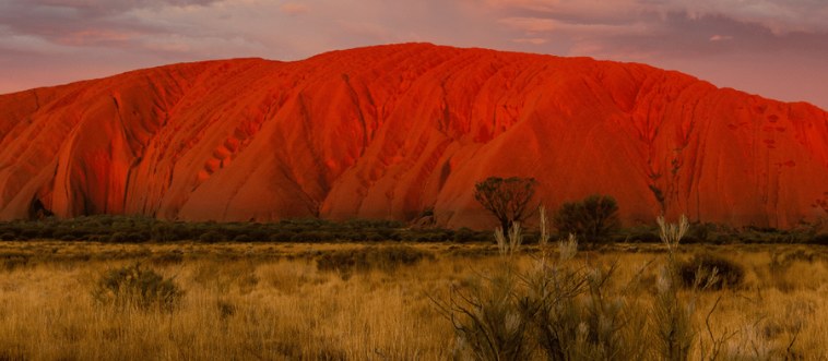 Our trivia expedition begins with a deep, earthy classic: which vast sun-baked desert hides the sacred giant red sandstone known as Uluru?